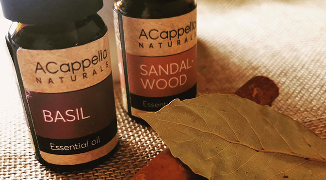 Bottles of sandlewood oil and basil